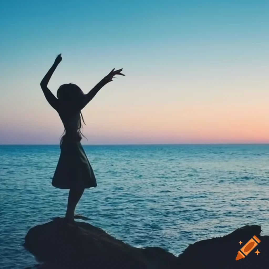 woman dancing on a rock by the sea