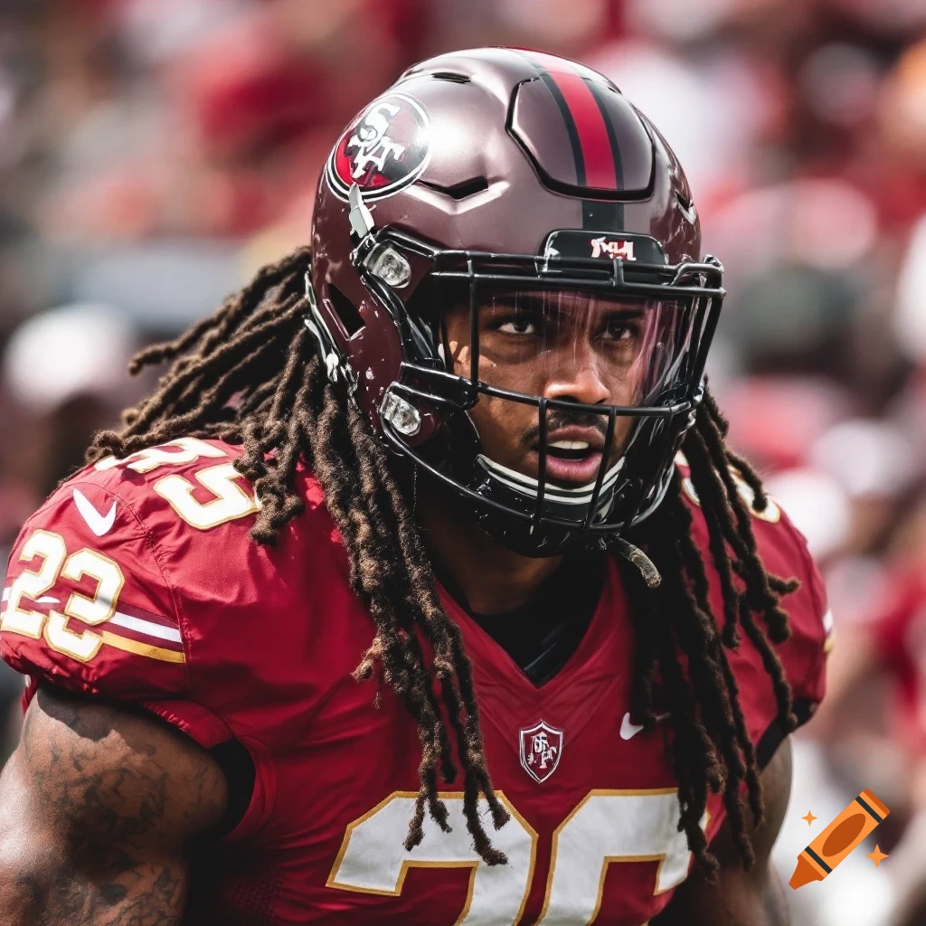 Close-up of a football player with dreadlocks in a red uniform and helmet with a visor on a sunny day.