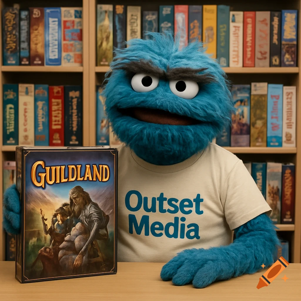 A blue furry puppet holding a 'Guildland' board game box, wearing an 'Outset Media' t-shirt, sitting at a desk in front of a bookshelf filled with games.