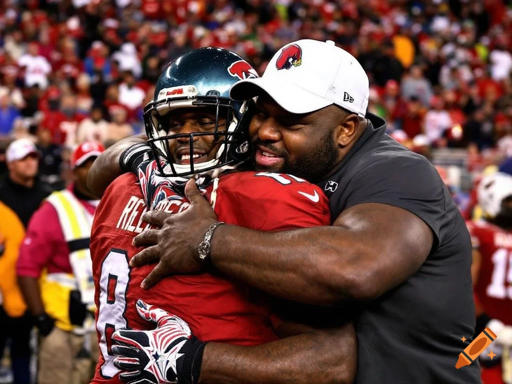 Man in football helmet hugging a man in a white cap on a football field with a crowd in the background