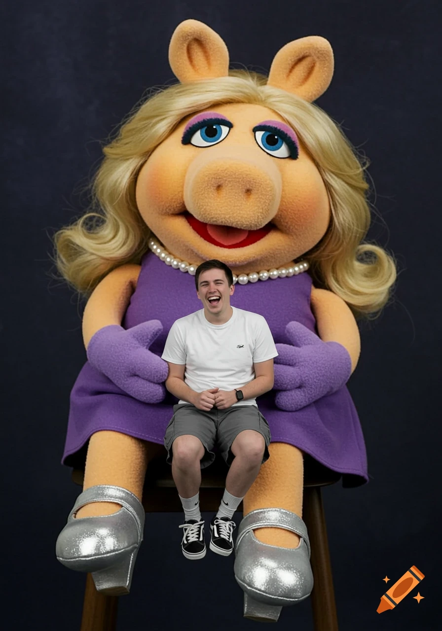 A man sits on the lap of a giant Miss Piggy doll.