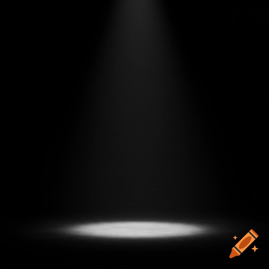 A spotlight shines down on a circular area on a dark stage.