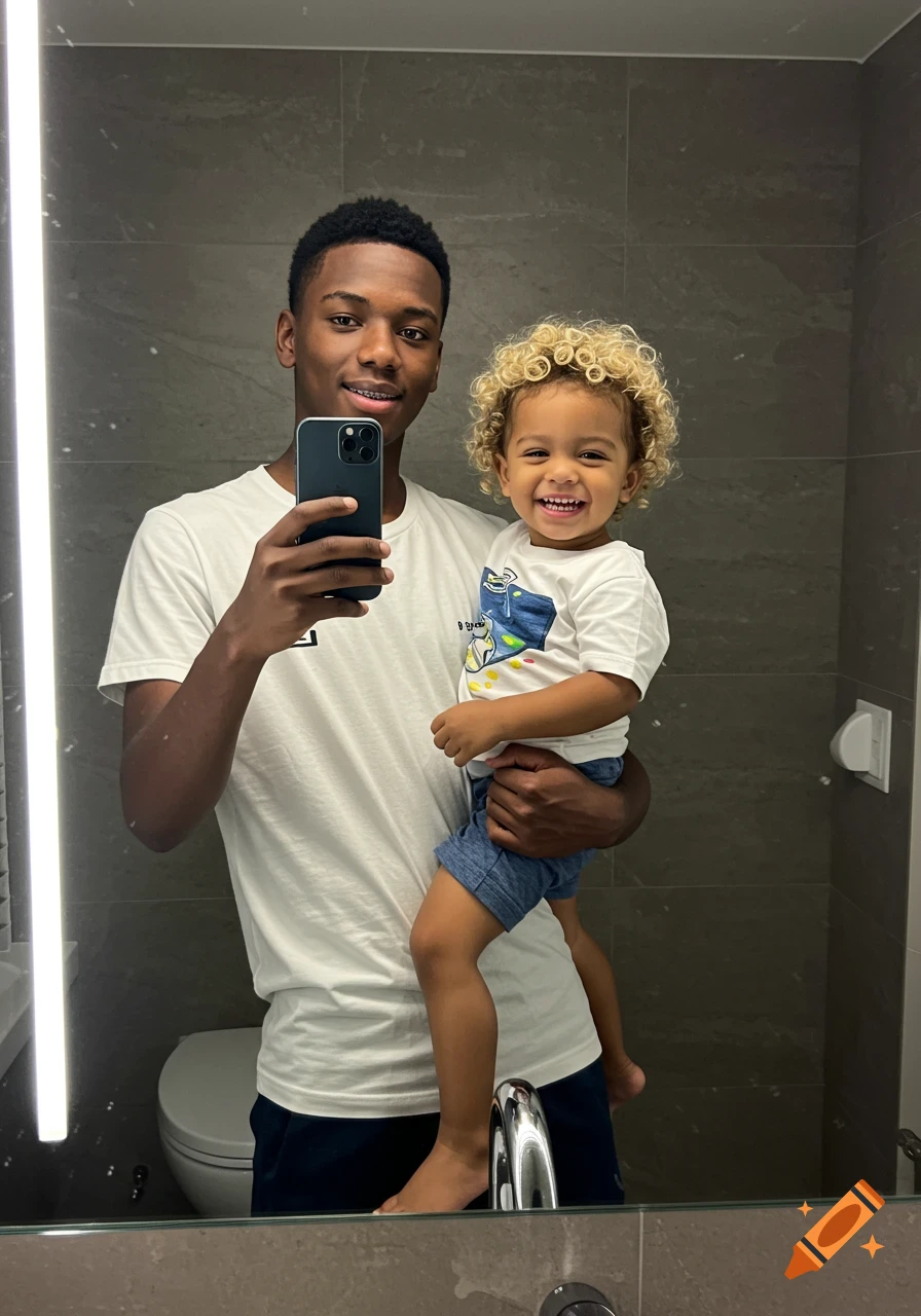 A young man holds a smiling child with curly blonde hair in a mirror selfie.