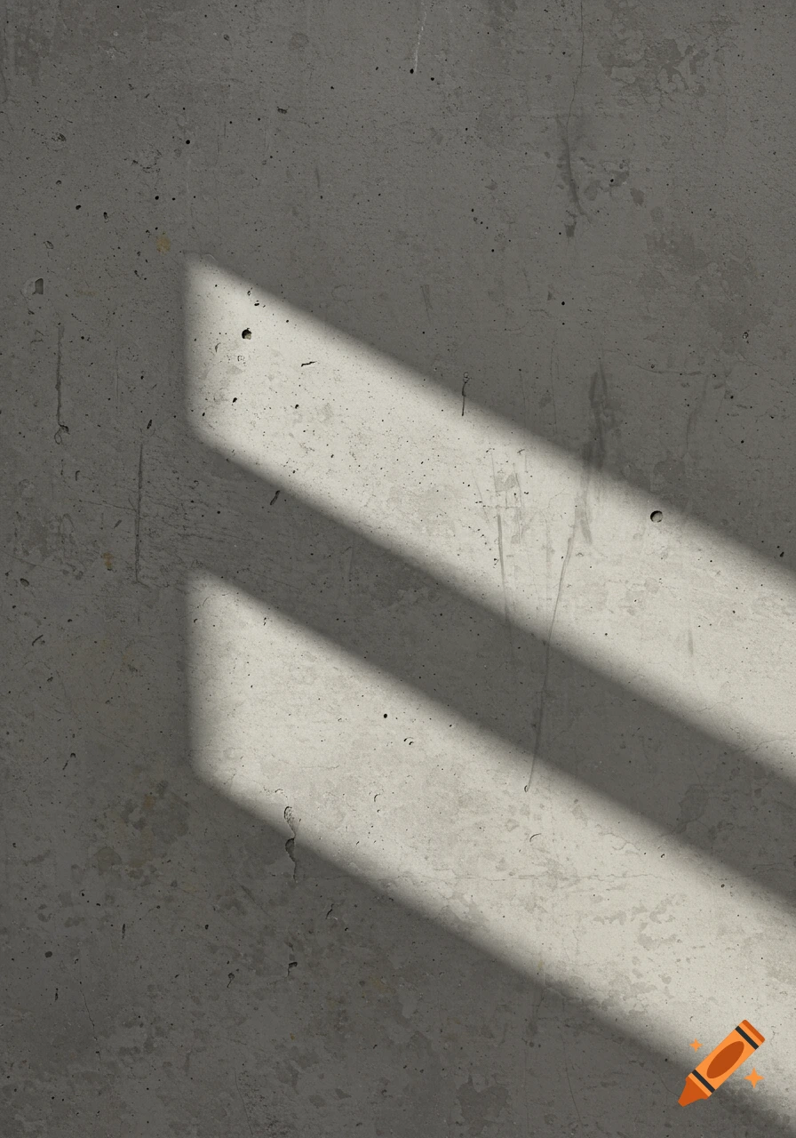 A grey concrete wall with two diagonal bands of sunlight casting shadows.