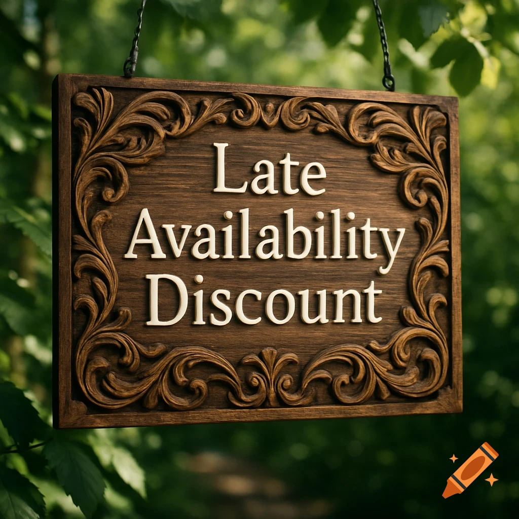 A carved wooden sign with the words 'Late Availability Discount' hangs among green tree leaves in a blurred natural setting.