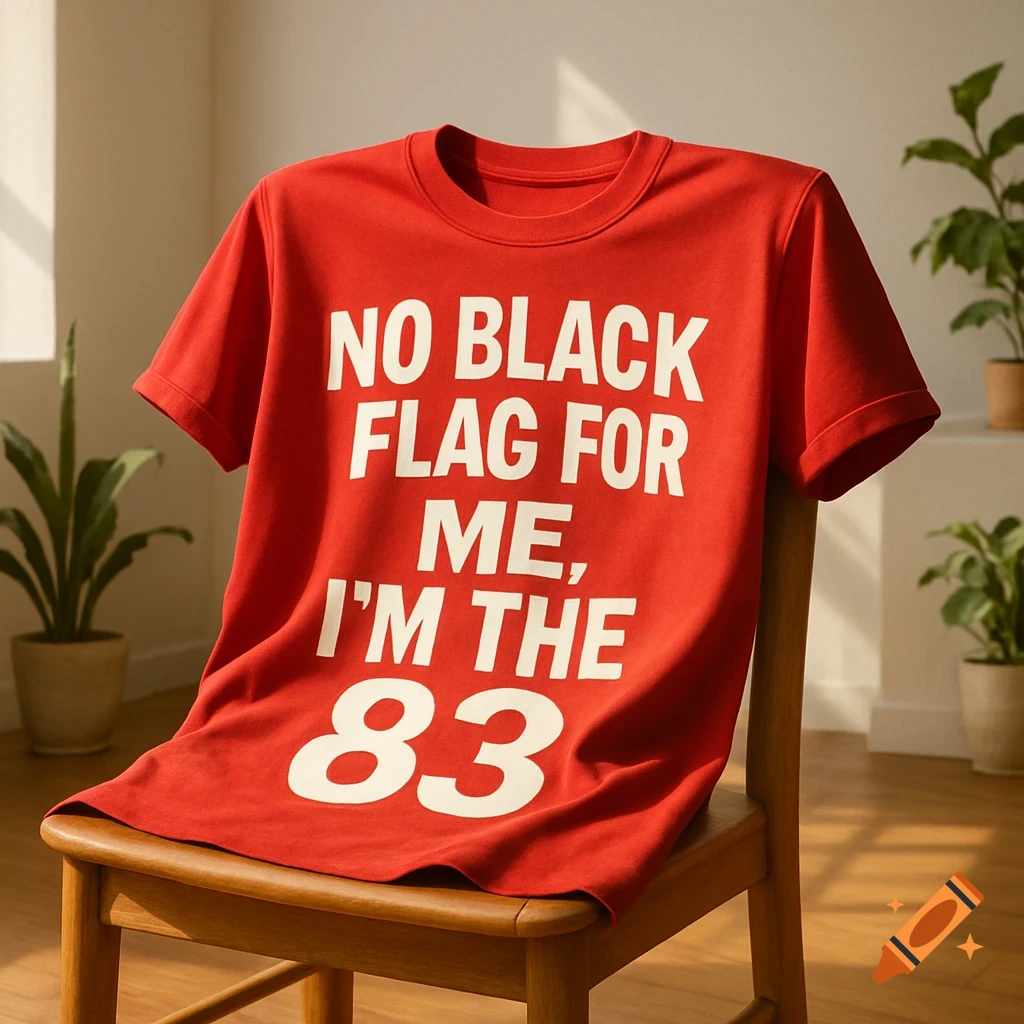 A red t-shirt with white text 'NO BLACK FLAG FOR ME, I'M THE 83' draped over a wooden chair.