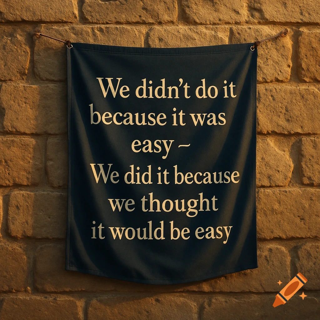 A dark blue fabric banner with a white quote hangs on a textured stone wall, lit by warm light.