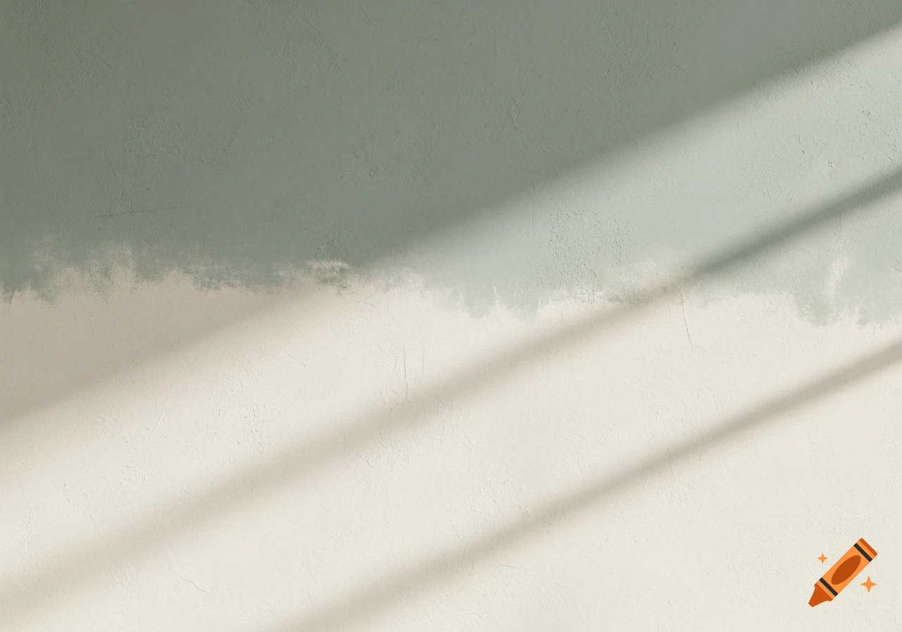 A textured wall, partially painted sage green over an off-white base, with sunlight casting diagonal shadows.