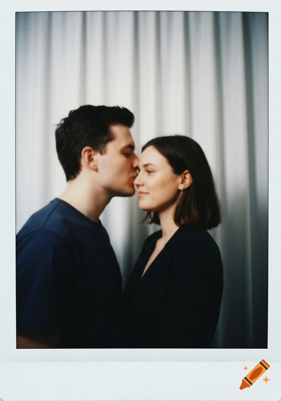 A man gently kisses a woman's forehead in a soft-focus polaroid photo against a white curtain.