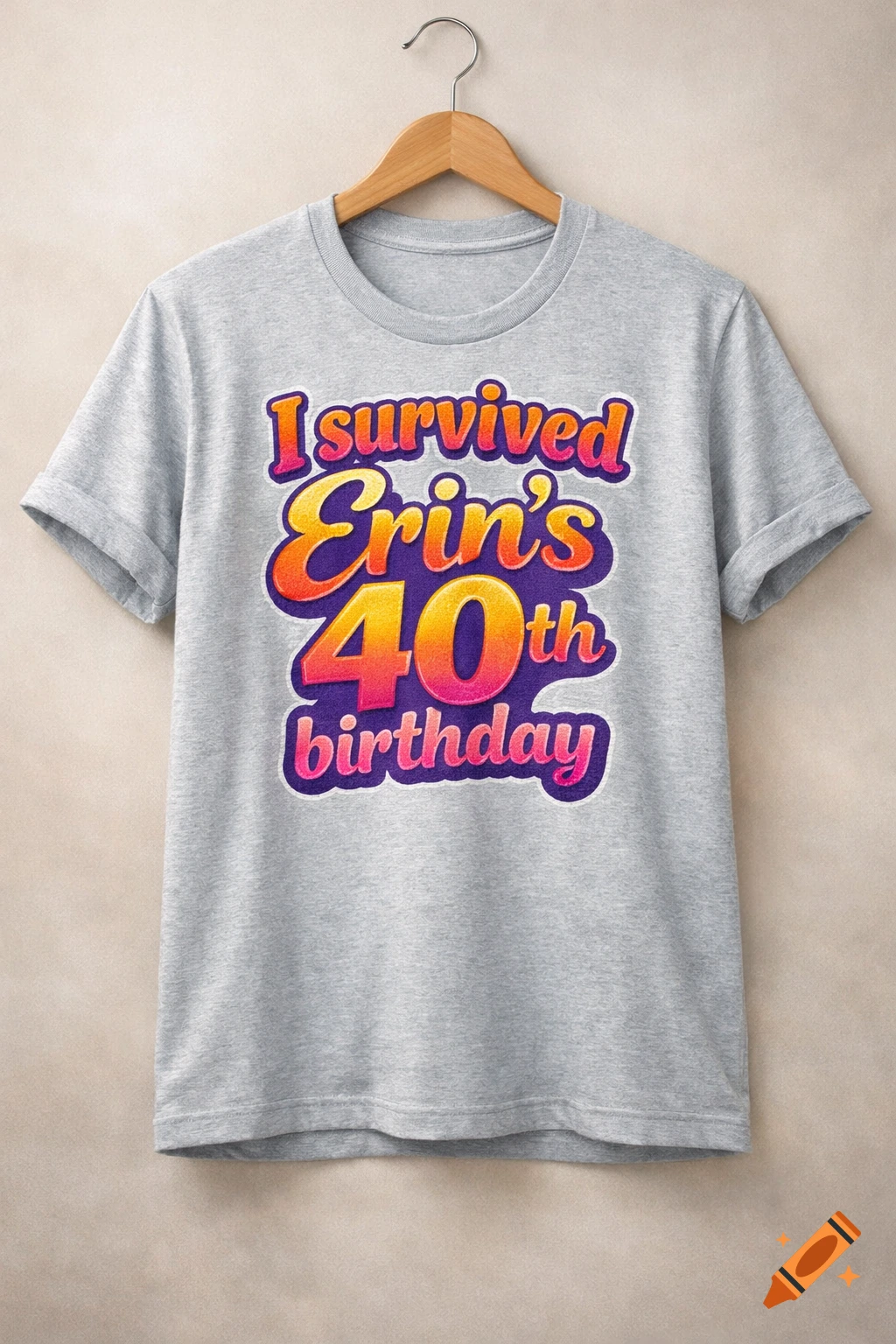 A grey t-shirt hangs on a wooden hanger against a beige wall, featuring colorful text "I survived Erin's 40th birthday".