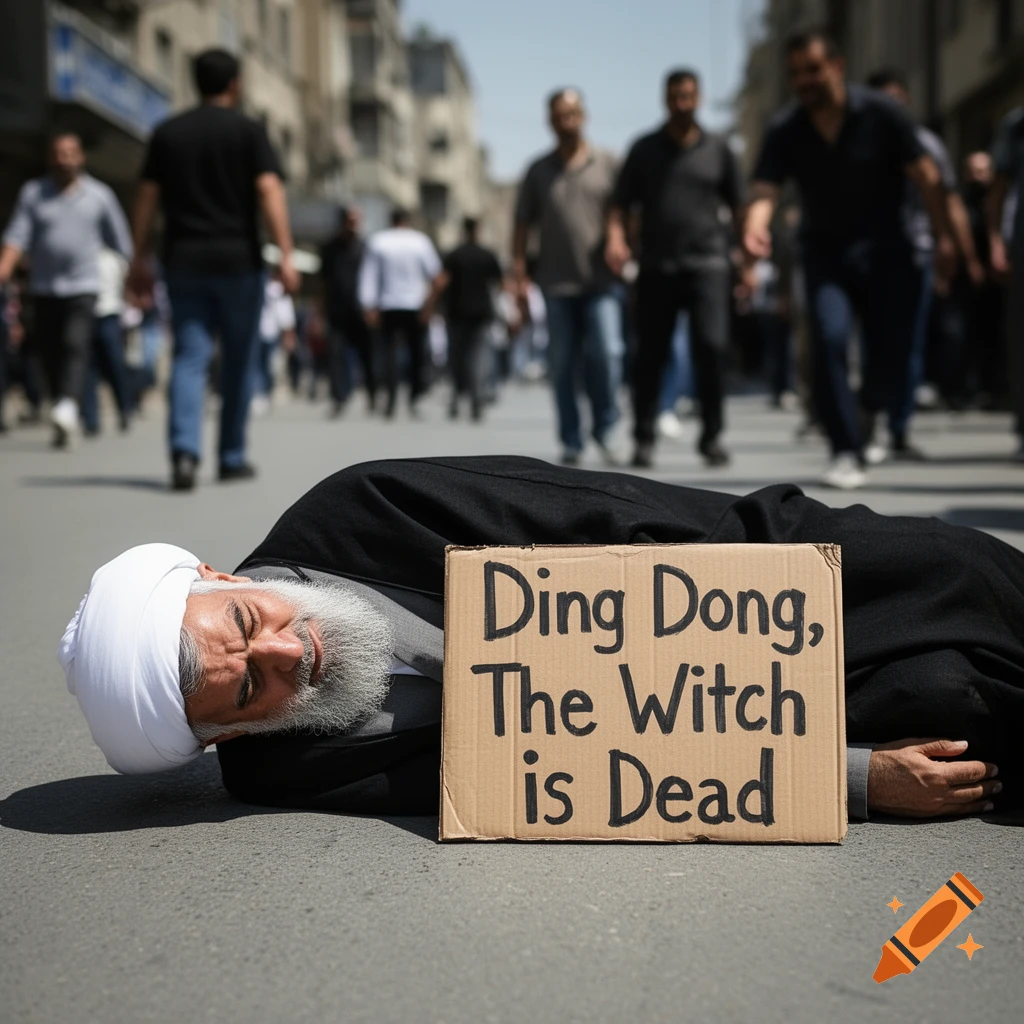 A man with a white turban and beard lies on a street next to a sign saying 'Ding Dong, The Witch is Dead', with blurred pedestrians behind.