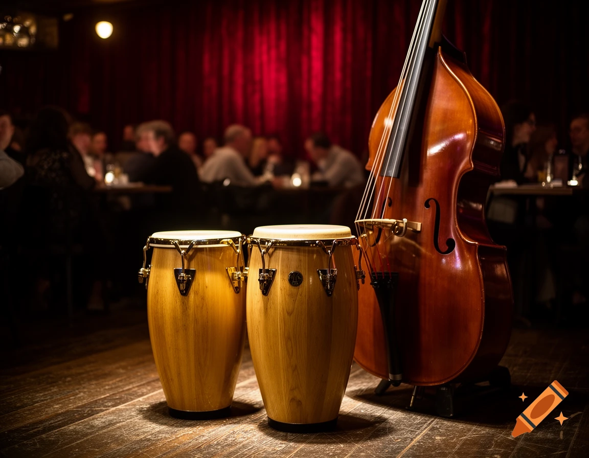 Two conga drums and a double bass stand on a wooden stage in a dimly lit club with a red curtain backdrop.