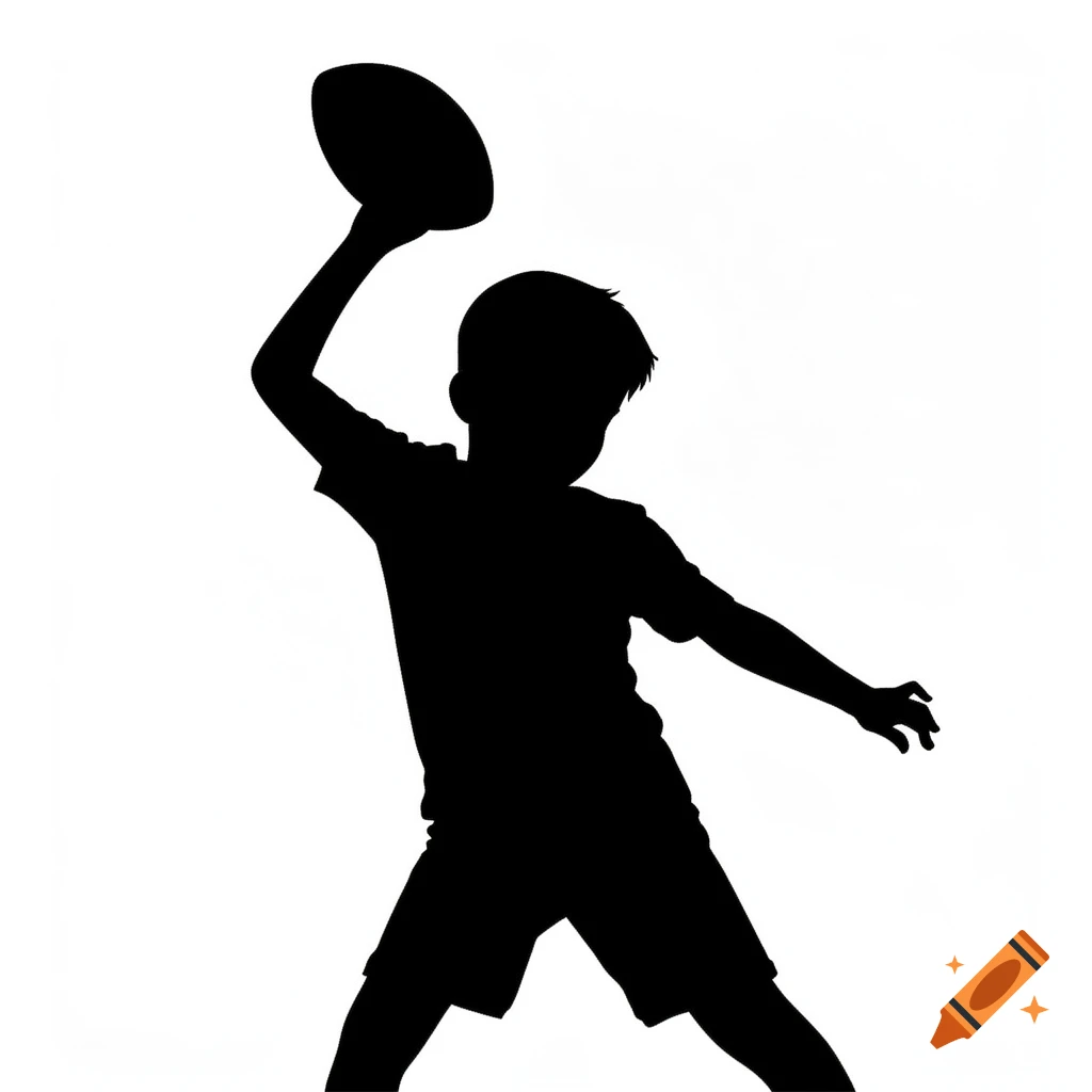 Silhouette of a young boy throwing a football.