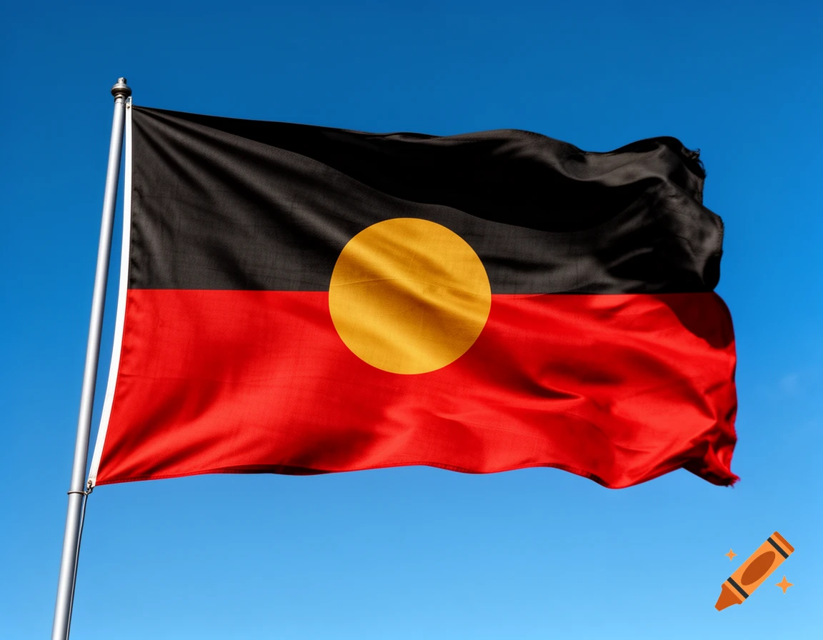 The Aboriginal flag, with its black upper half, red lower half, and yellow circle, waves against a clear blue sky.
