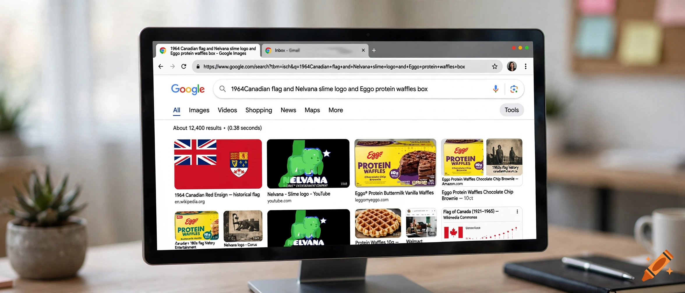 A computer monitor displaying a Google image search results page on a wooden desk.